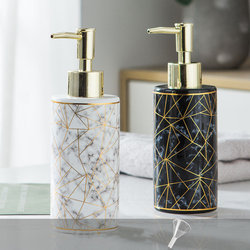 Elegant bathroom accessory with gold pump for soap or lotion, placed on a modern minimalistic background.