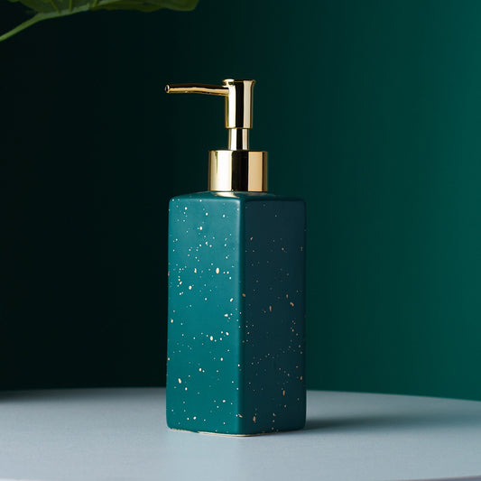 Elegant bathroom accessory with gold pump for soap or lotion, placed on a modern minimalistic background.