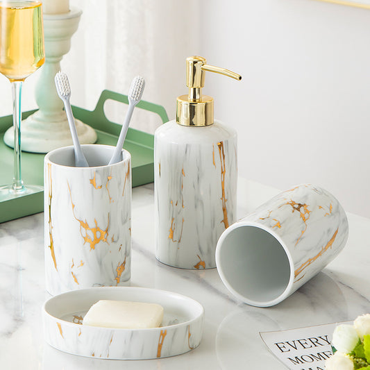 Elegant bathroom accessory with gold pump for soap or lotion, placed on a modern minimalistic background.